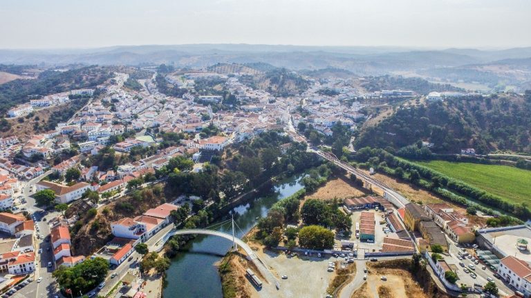Vista aerea da Vila de Odemira com casas casario, ponte pedonal, Rio Mira, Zona Ribeirinha